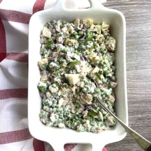 English pea salad in a white dish.