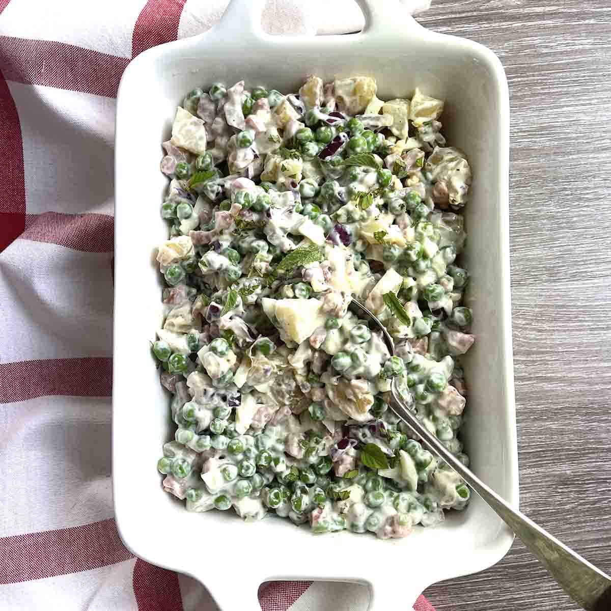 English pea salad in a white dish.