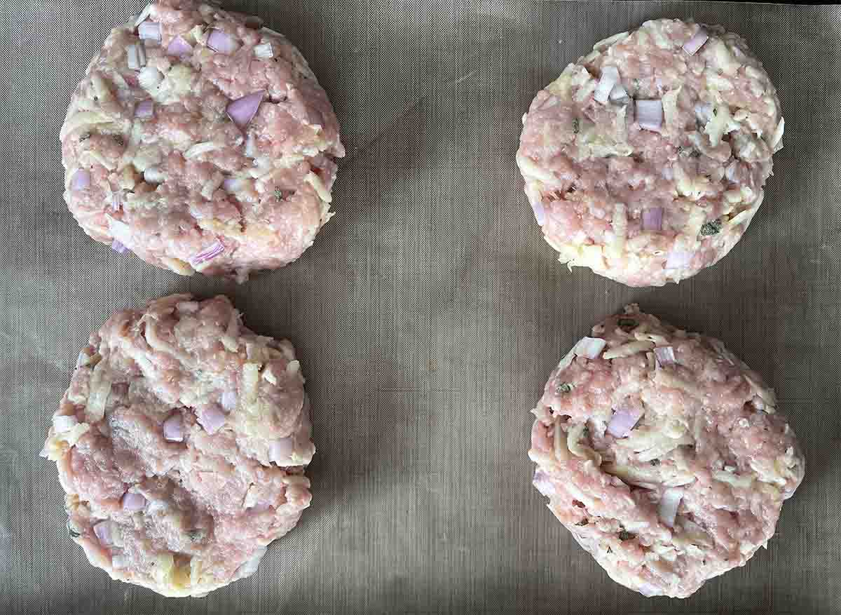 4 burgers on a tray.