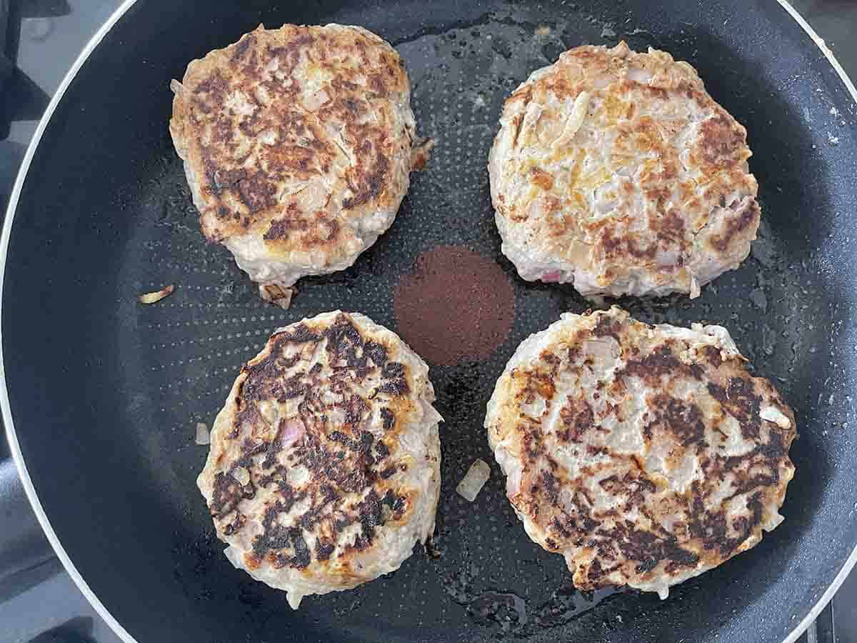 burgers cooked on one side.