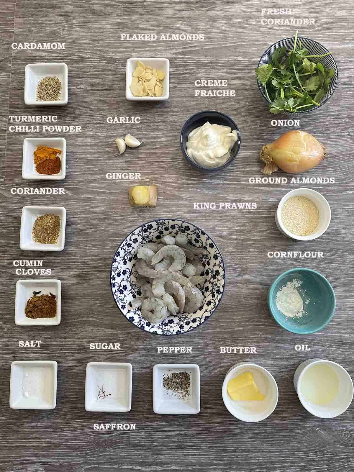 ingredients in bowls including prawns, spices and ground almonds.