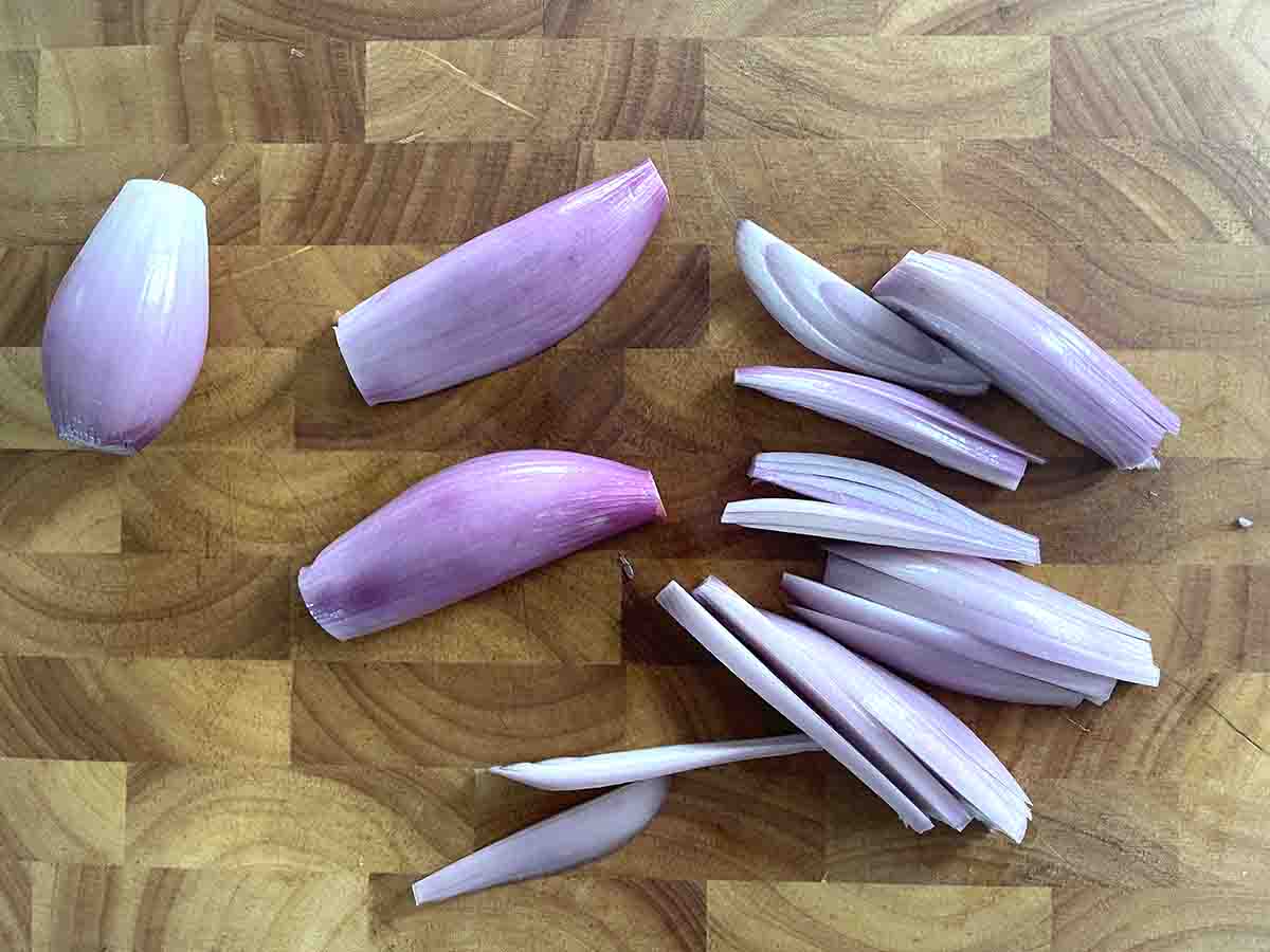 sliced shallots on a board.