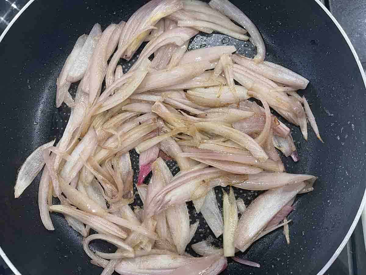 shallots frying in a pan.