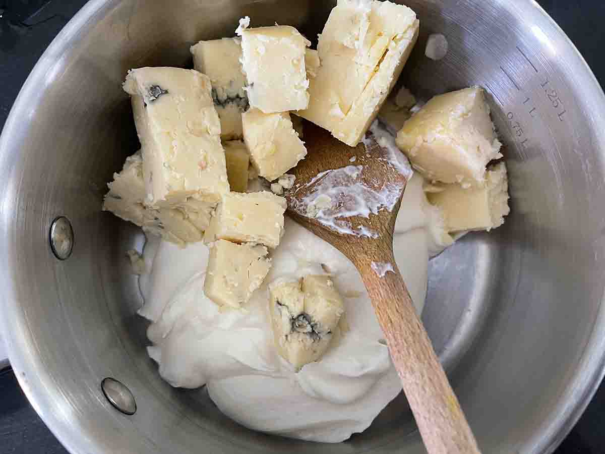 stilton cheese in a saucepan.