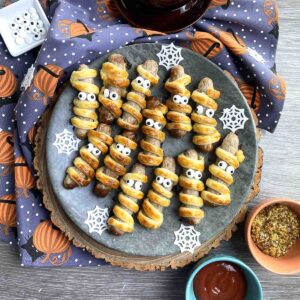 Halloween sausage rolls on a plate.