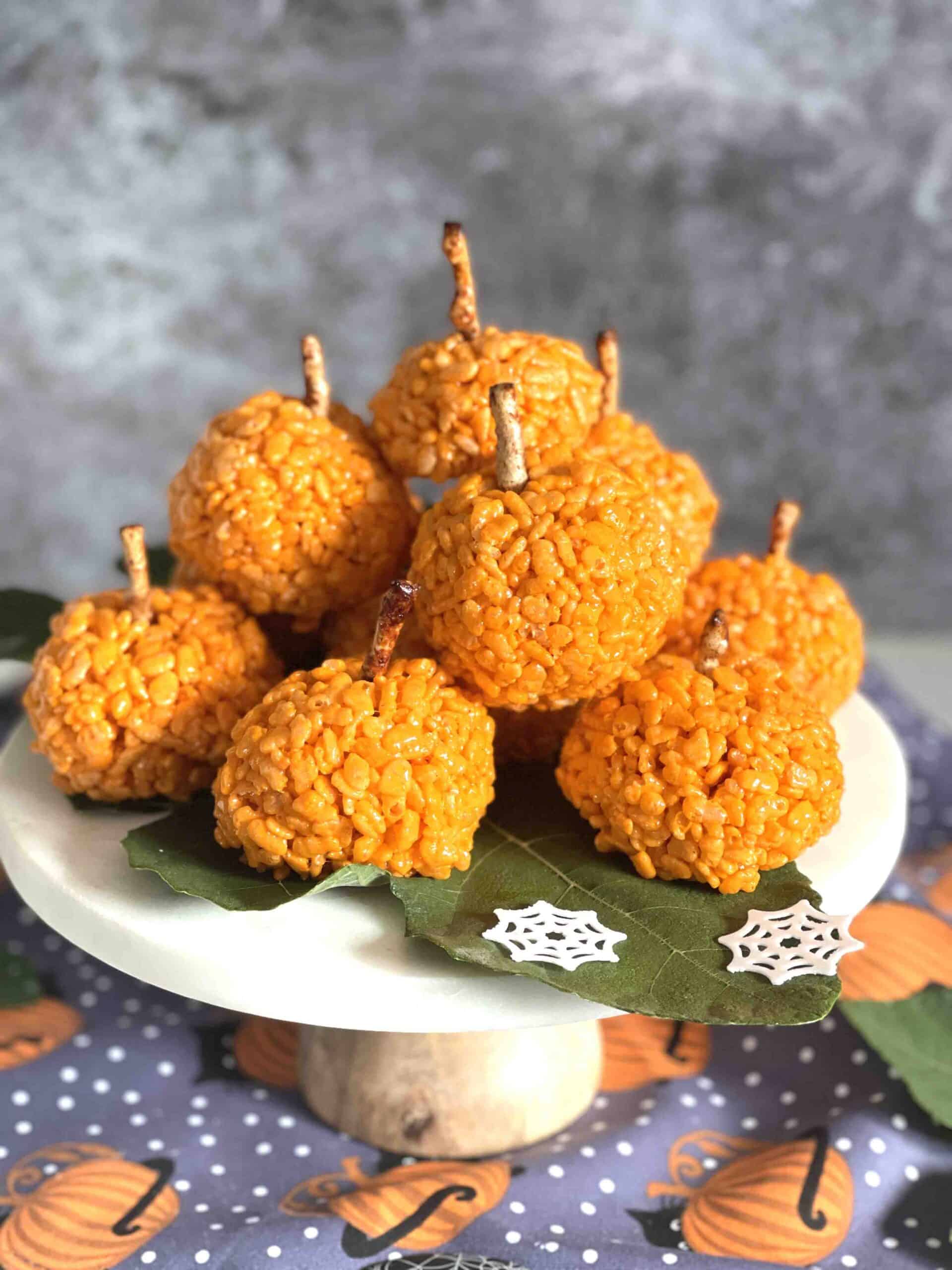 rice krispie pumpkins on a plate.