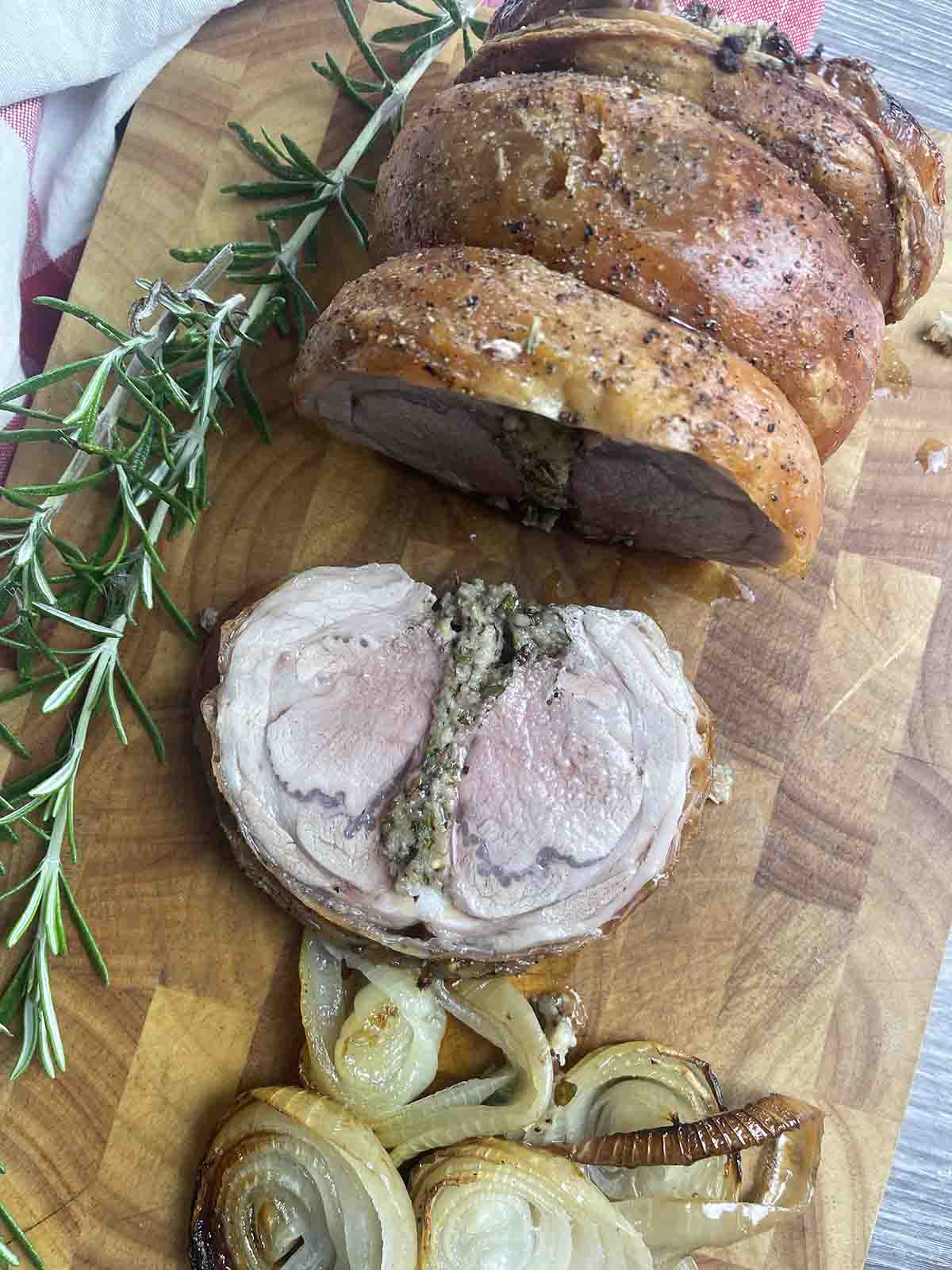 roast saddle of lamb on a board.