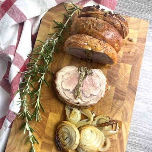 roast saddle of lamb on a board.