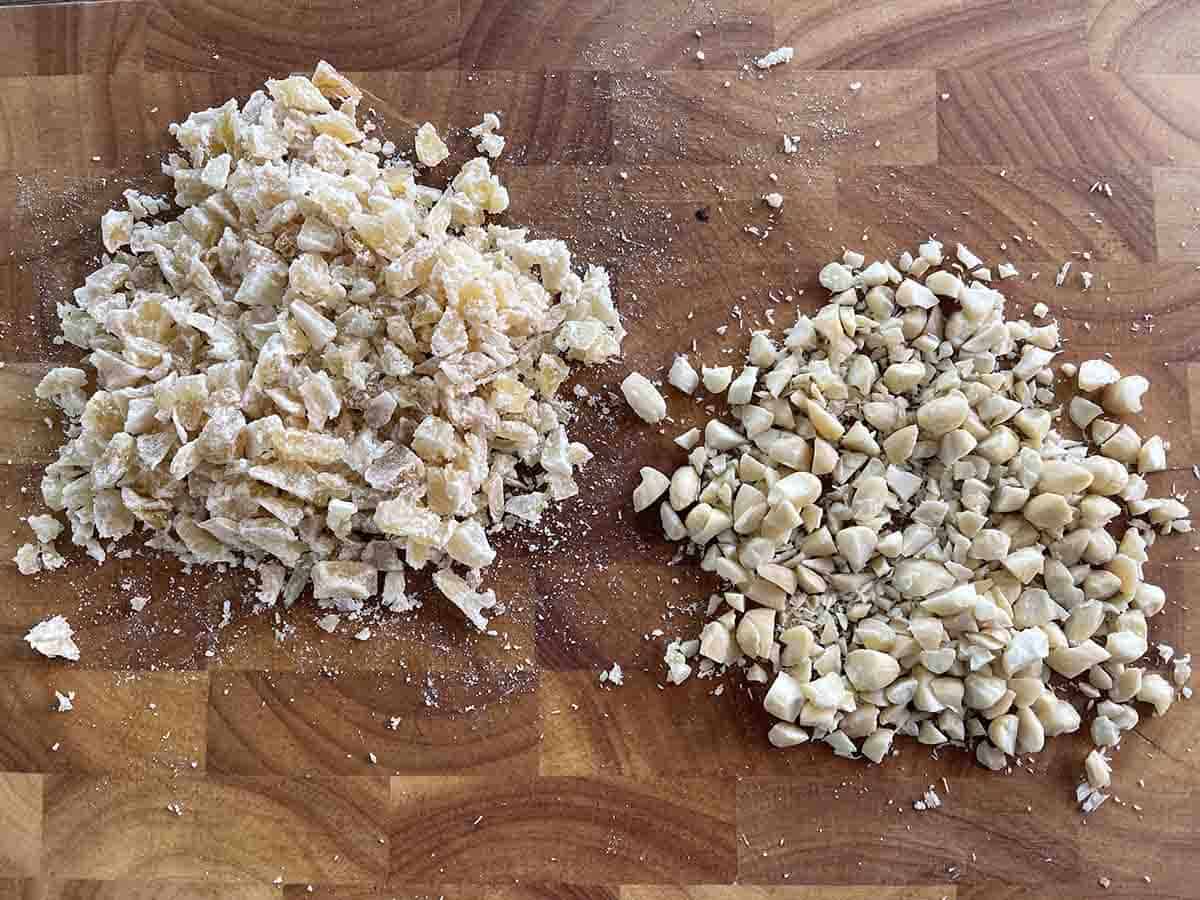 chopped almonds and ginger on a board.