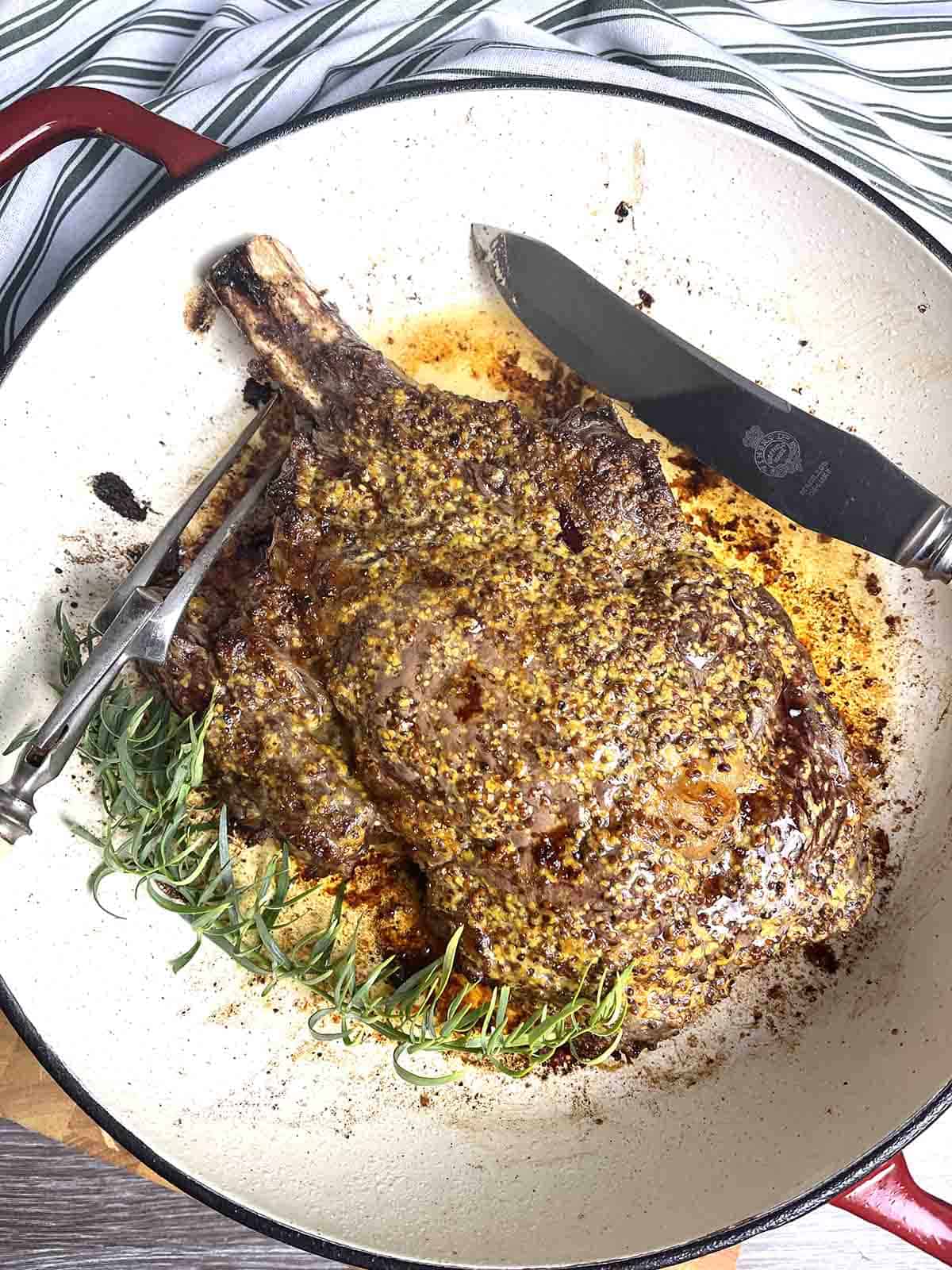cooked roast prime ribeye in a pan.