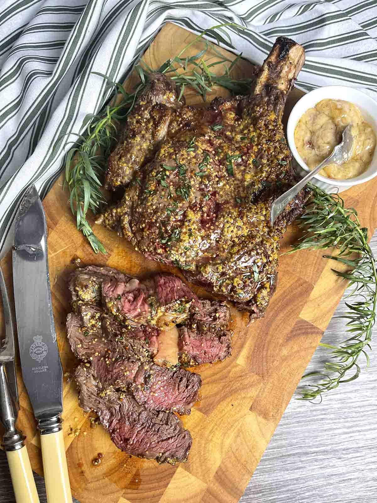 slow ccowboy steak sliced on a board.