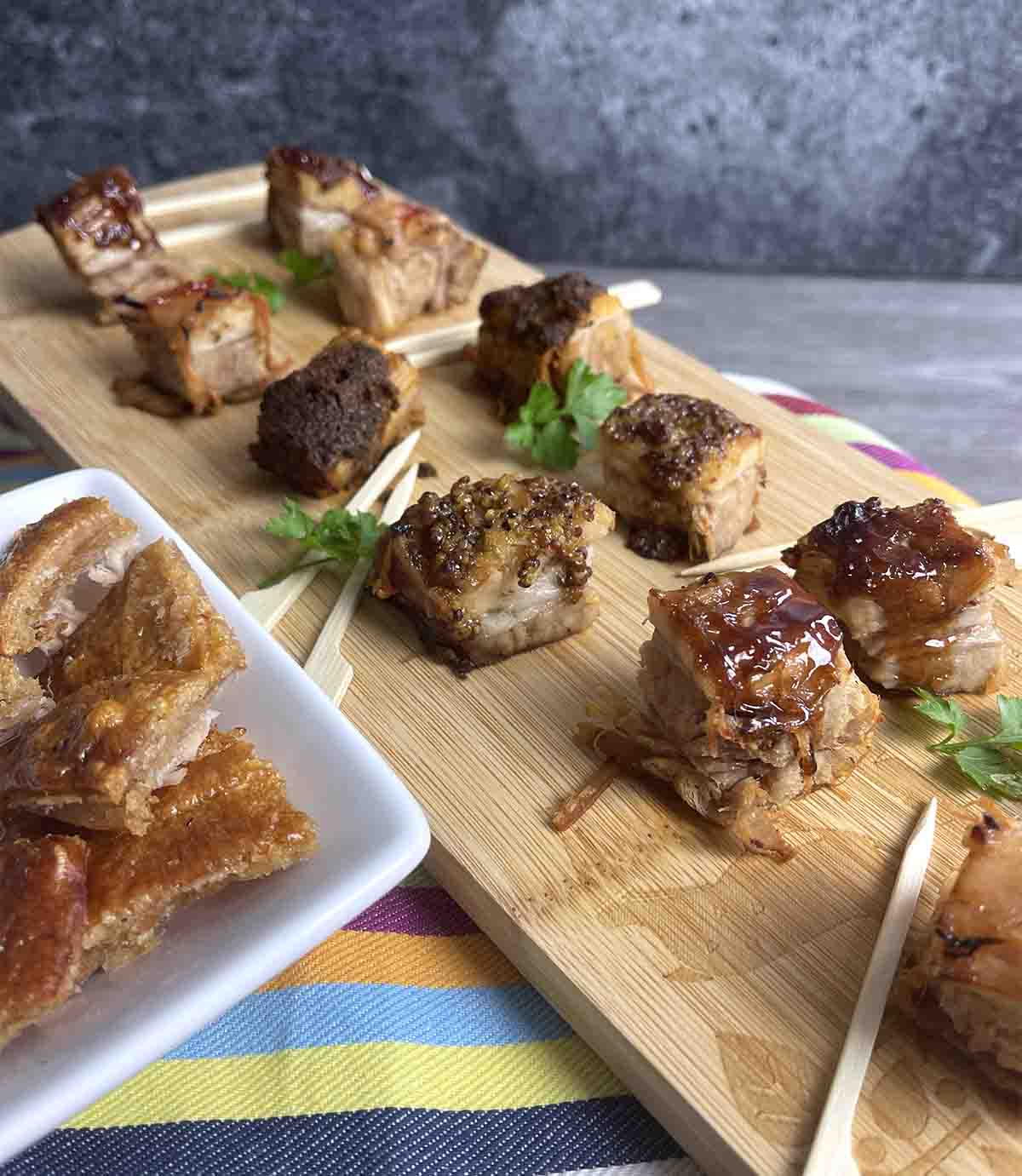 pork belly appetizers on a board.