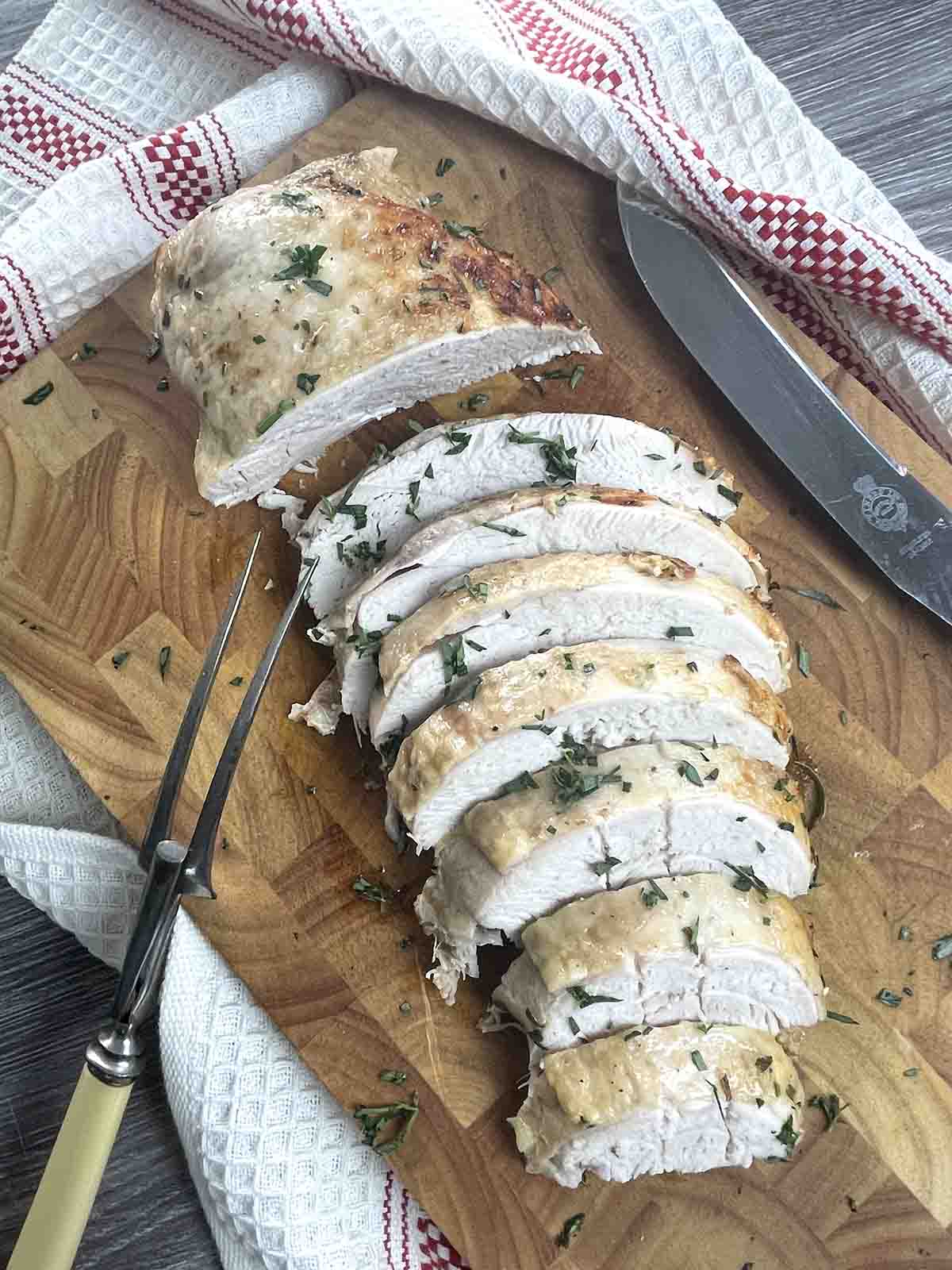 slow cooker turkey crown sliced on a board.