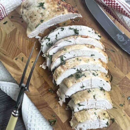 slow cooker turkey crown sliced on a board.