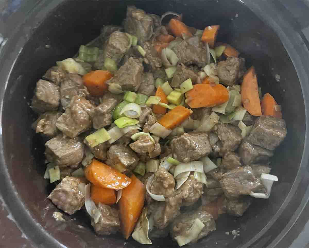 meat and vegetables in slow cooker.