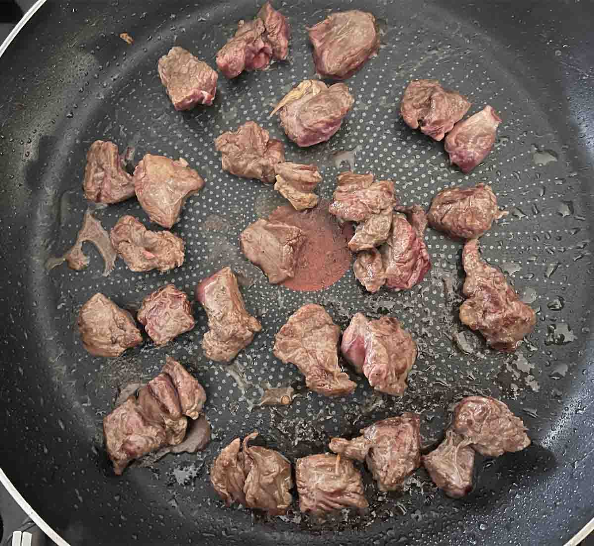 seared venison in a pan.