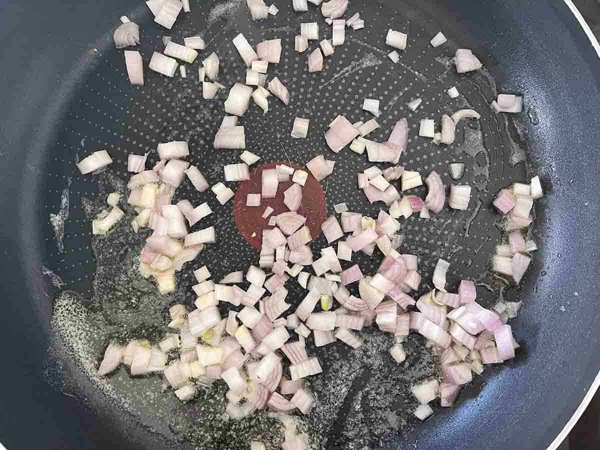 shallots added to a pan.
