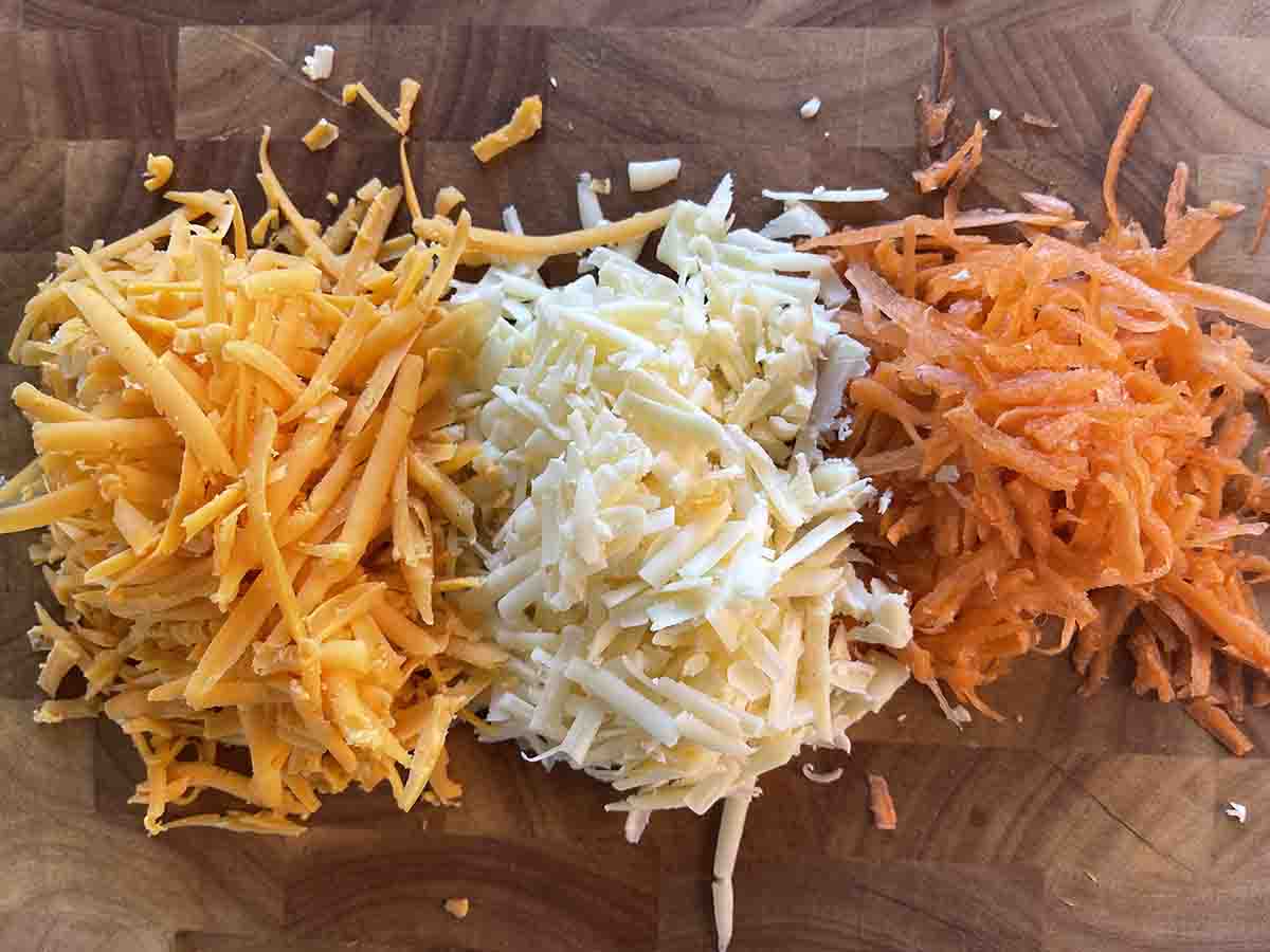 grated cheese and carrot on a board.