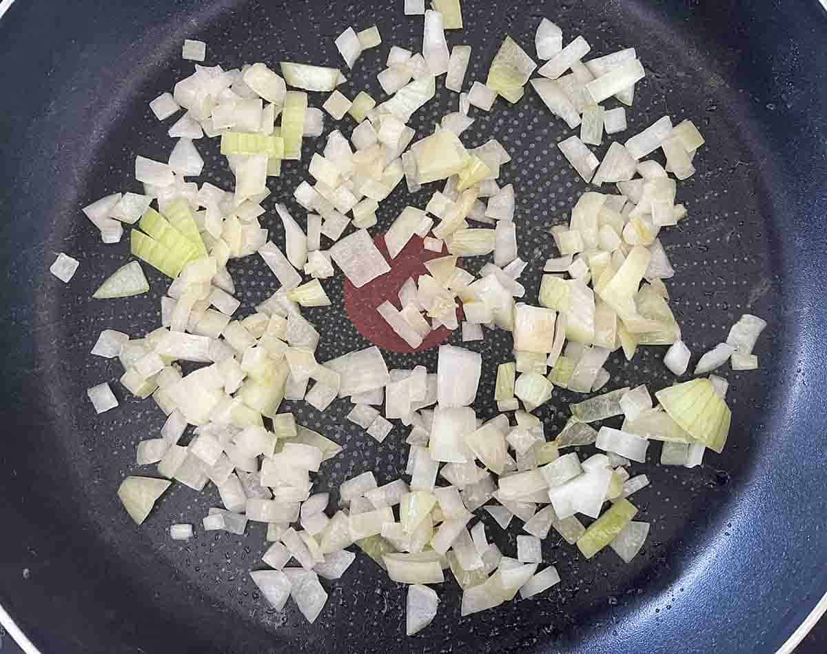onions frying in a pan.
