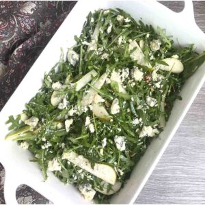 pear and rocket salad in a white dish.