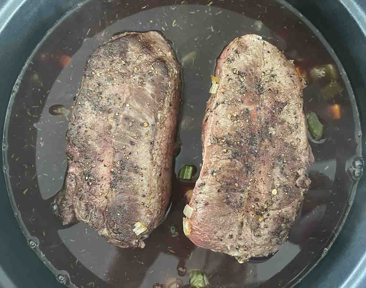 vegetables, meat and stock added to casserole dish.