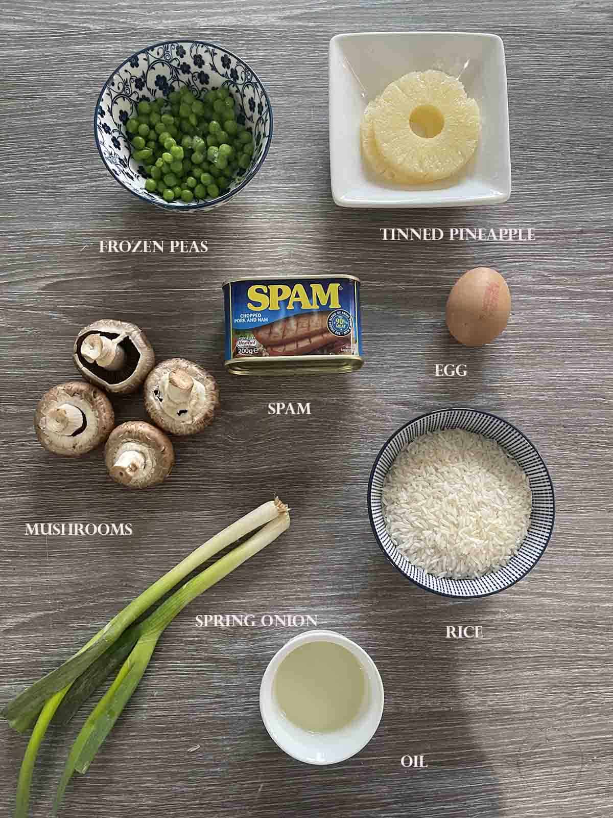 ingredients including rice, spam, pineapple, mushrooms and peas.