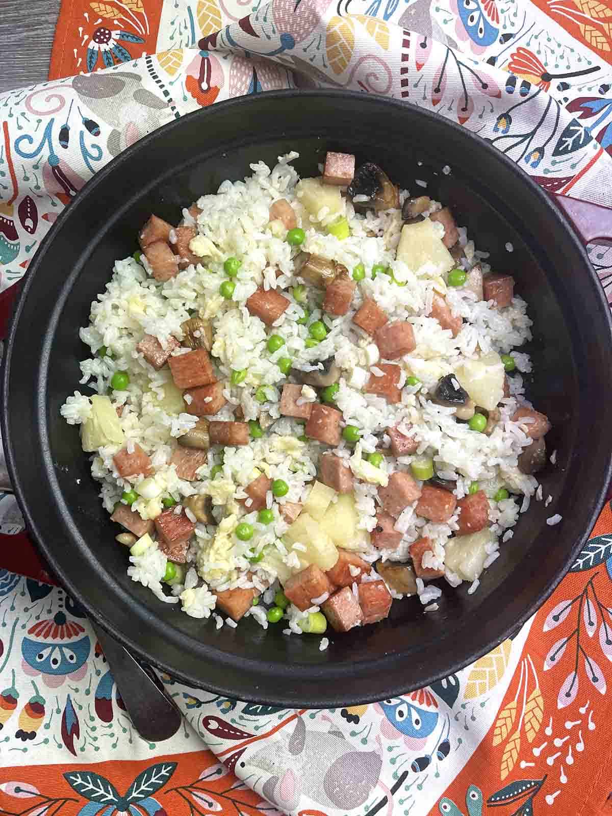 spam and pineapple fried rice in a dish.
