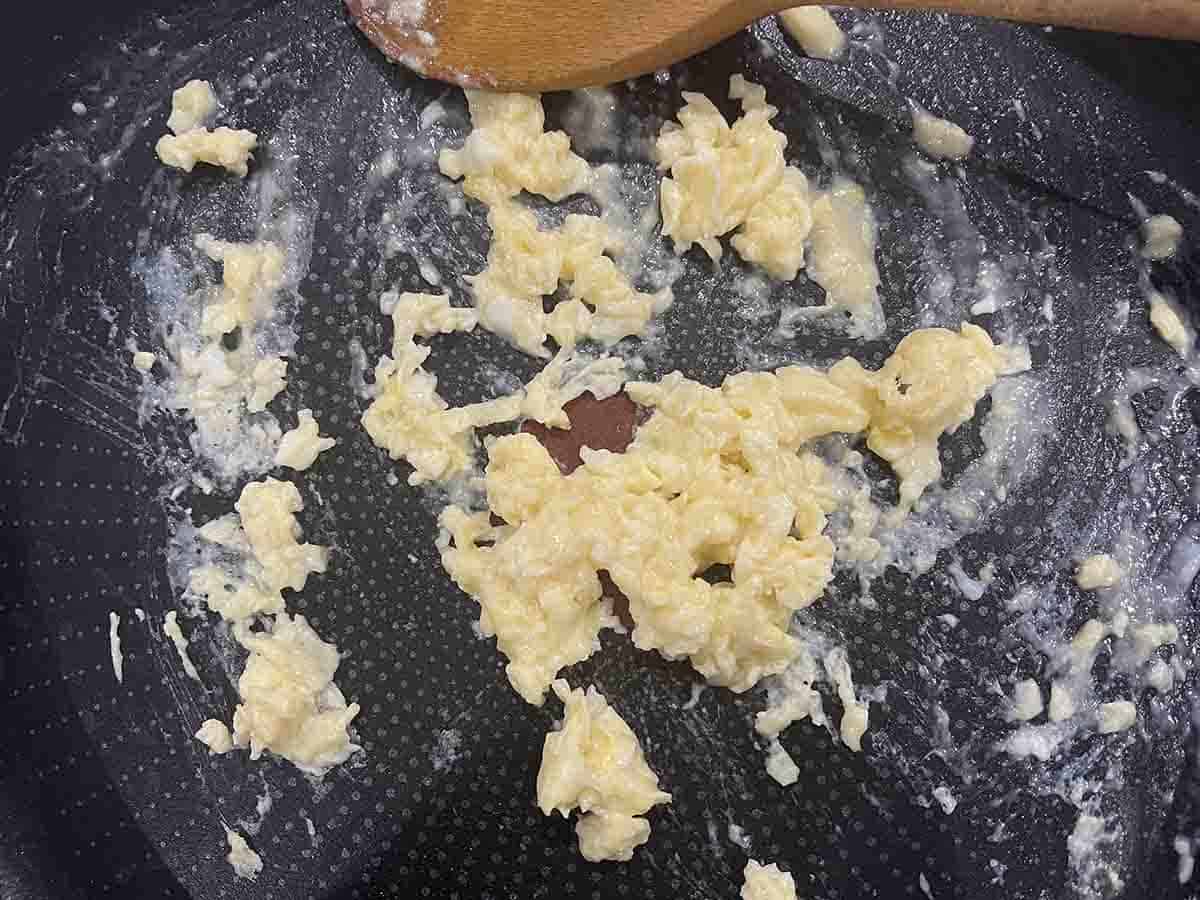 eggs scrambled in a pan.