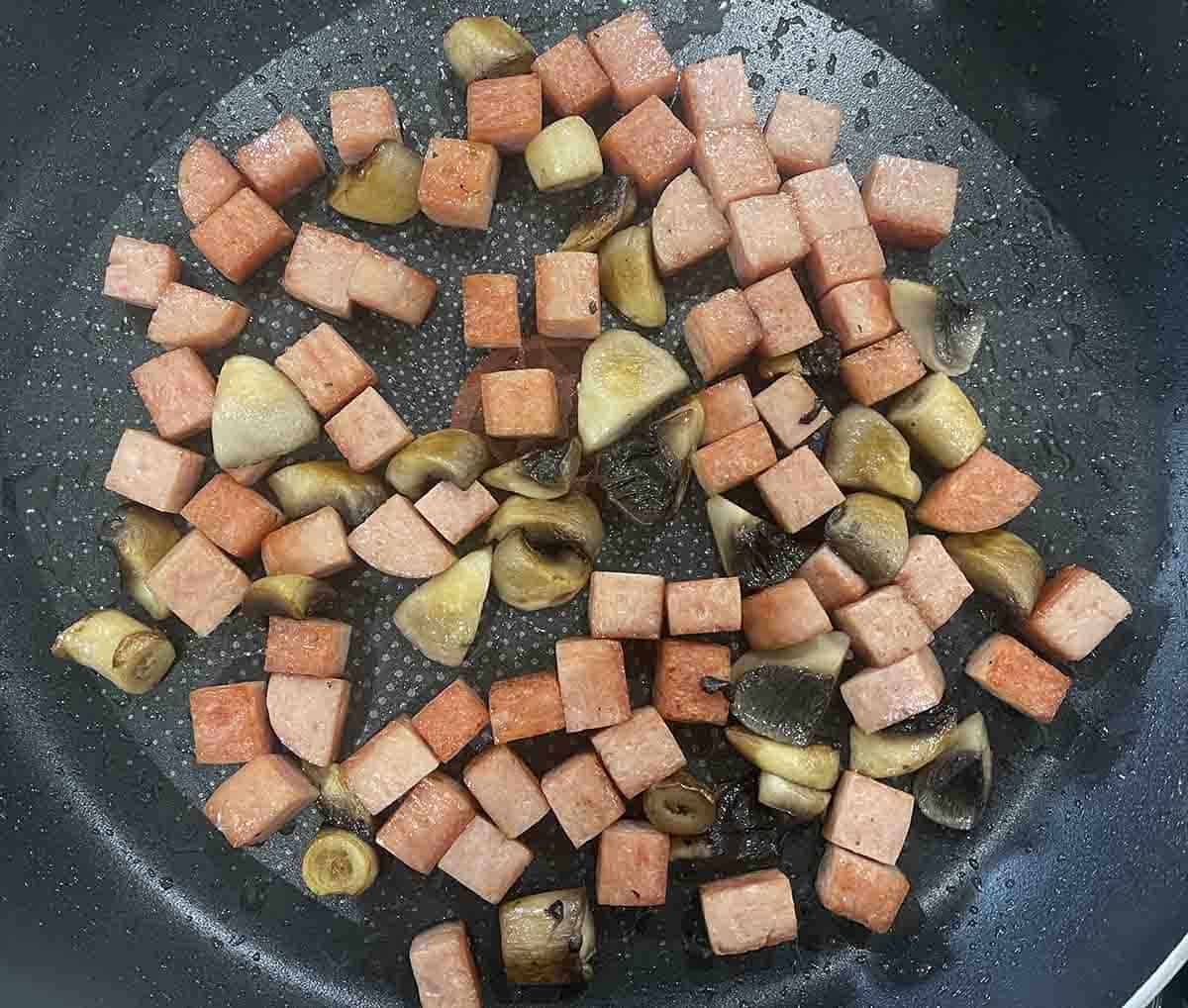 spam frying in a pan.