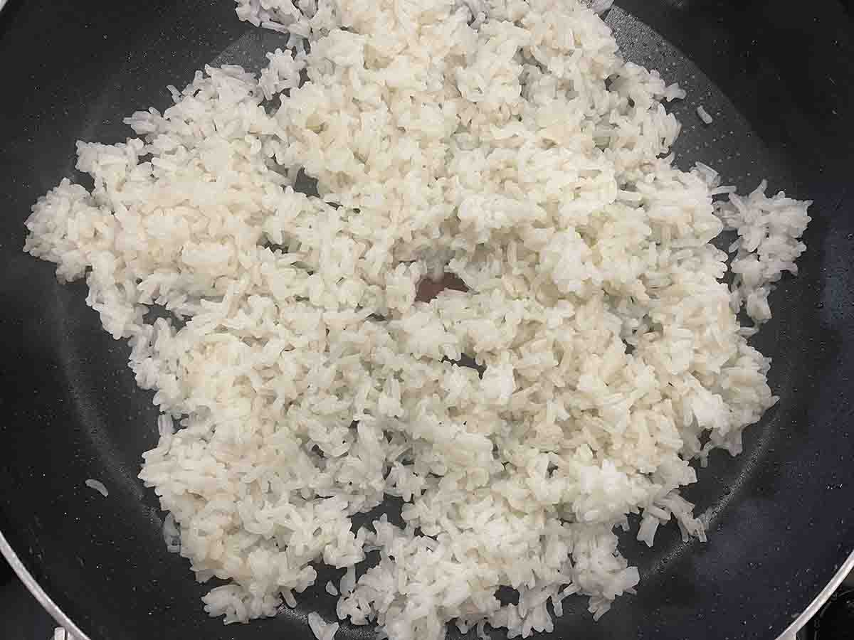 cooked rice heating in a pan.