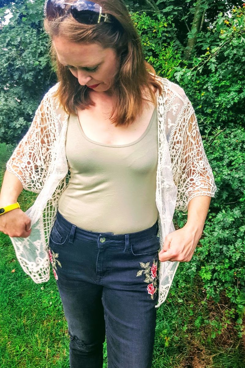 Faded Ripped Jeans With Roses On And Holes In Knee