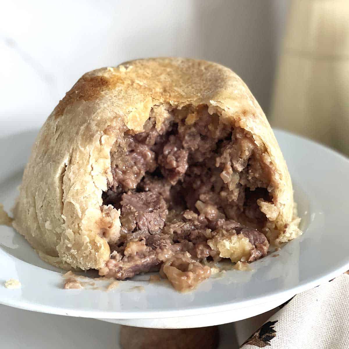 steak and kidney pudding with portion taken.