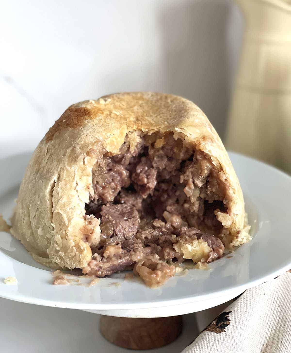 steak and kidney pudding with portion taken.