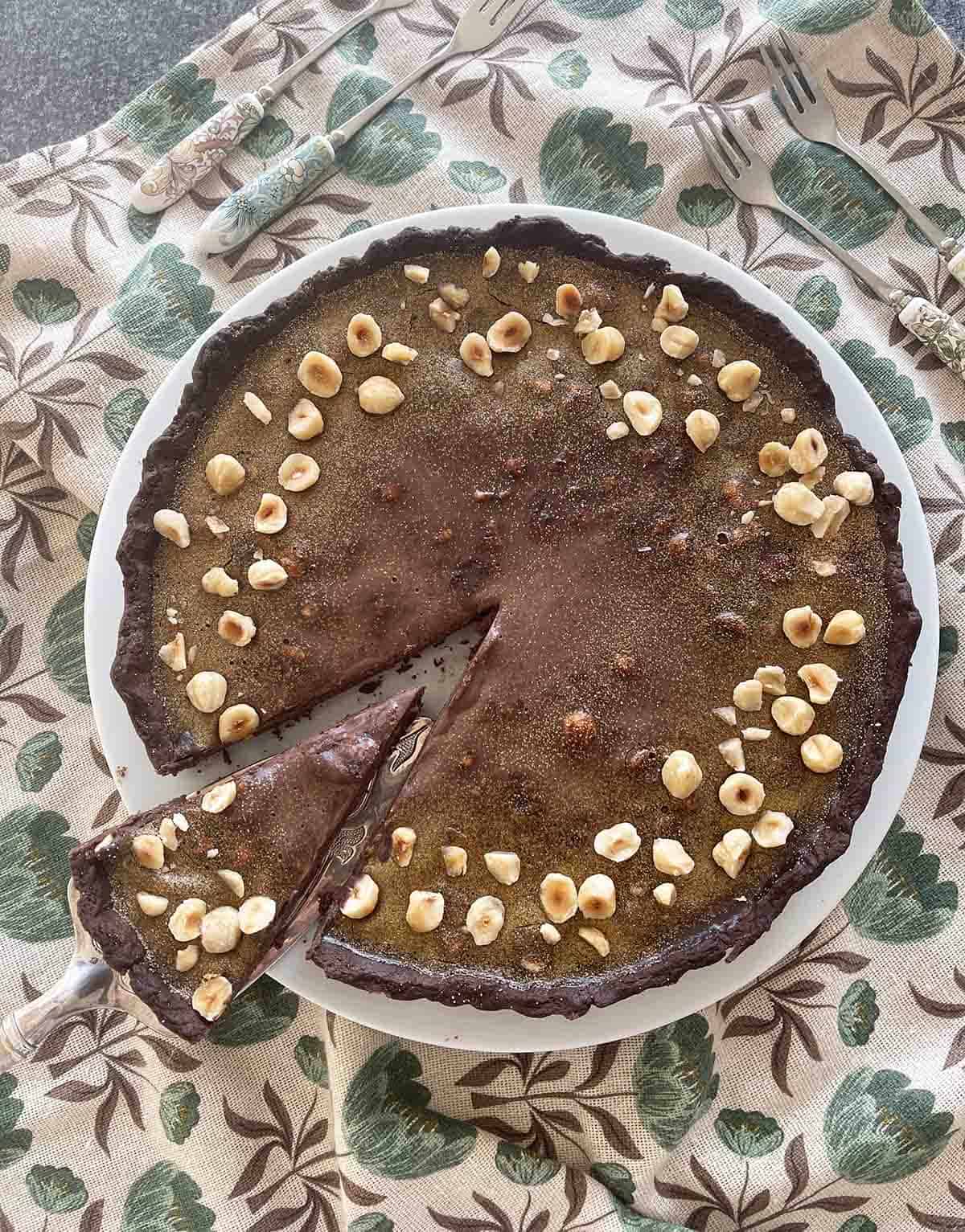 chocolate hazelnut tart on a plate.