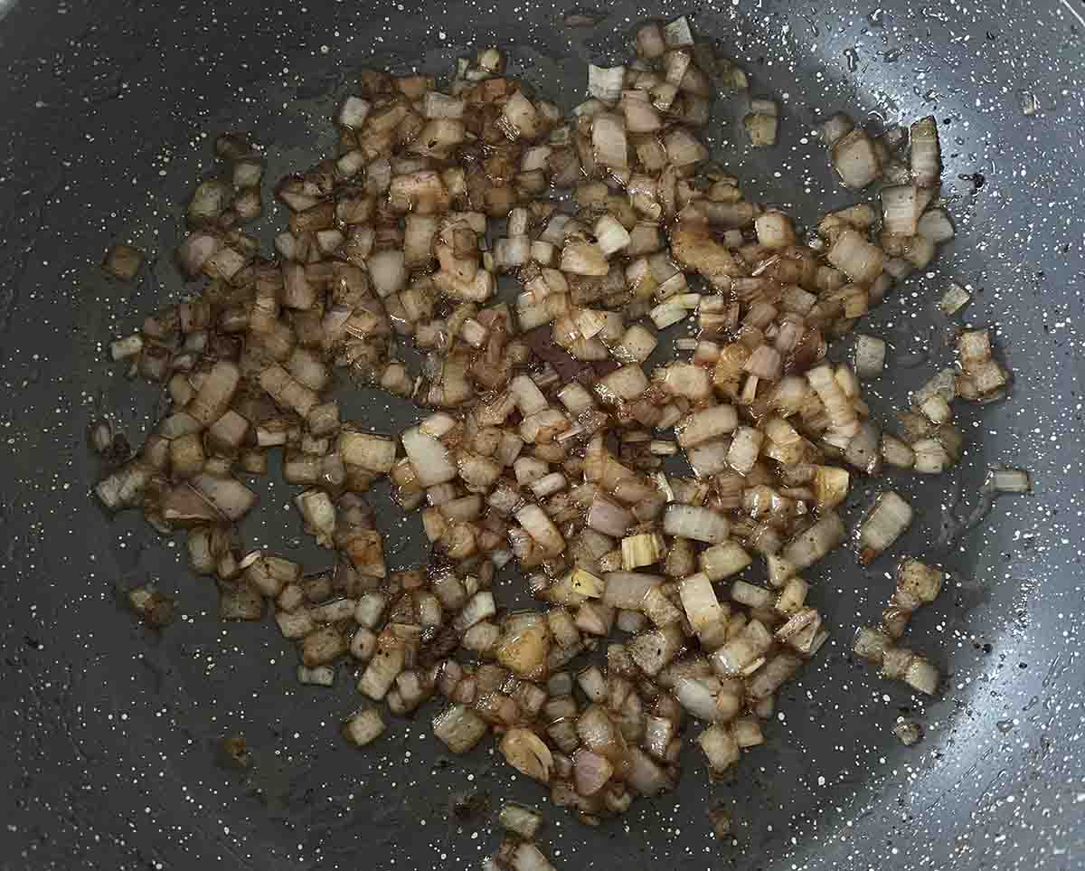 shallot softening in a pan.