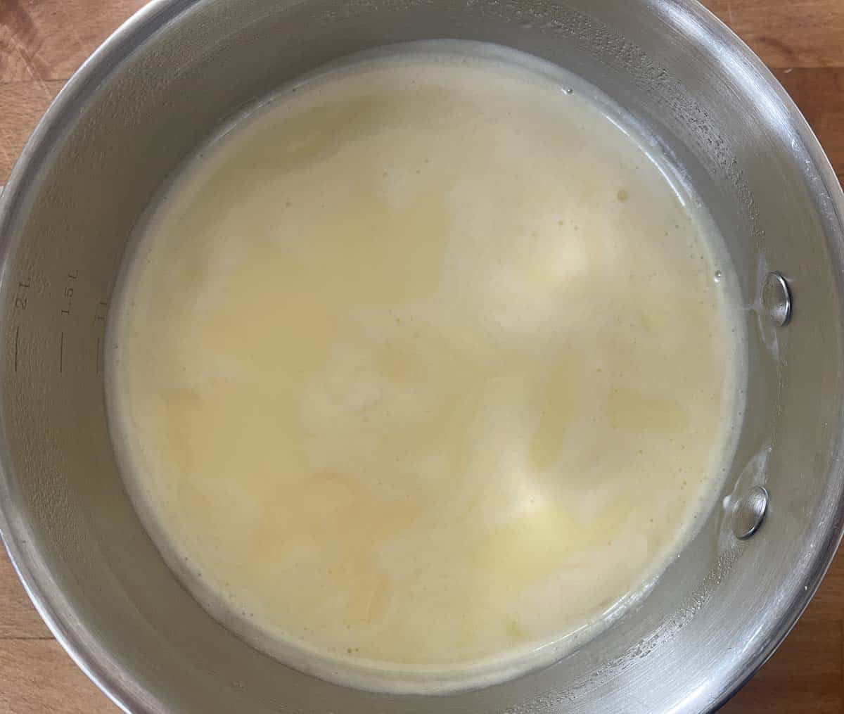 simmering cream and sugar in a pan.